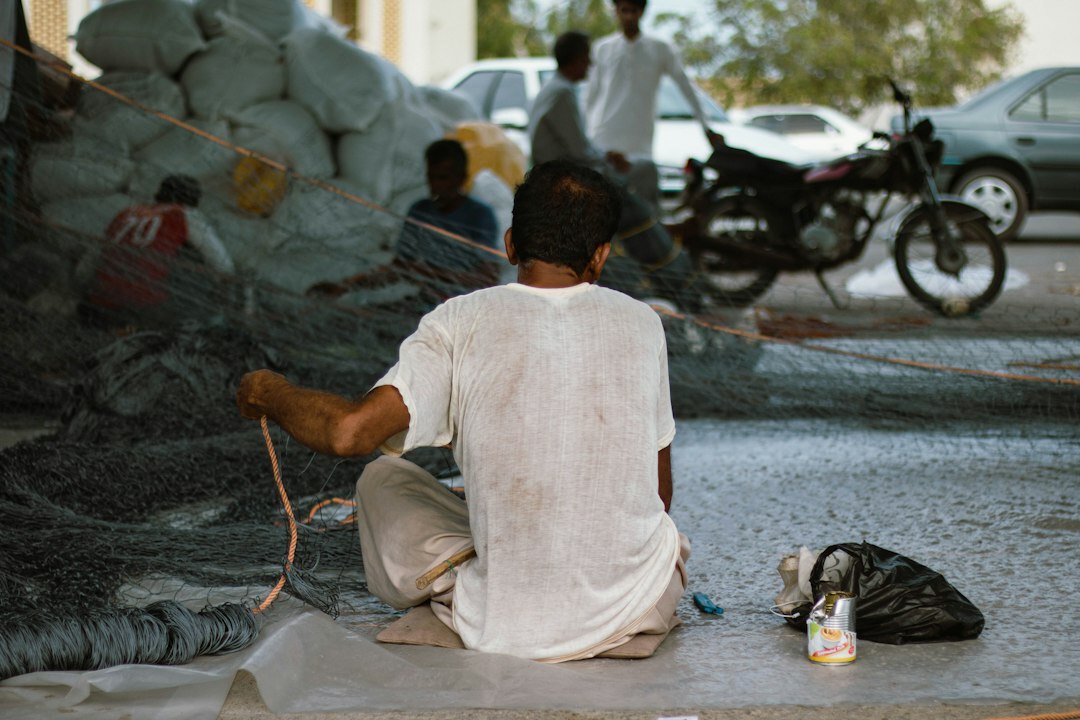 fisherman repairing net