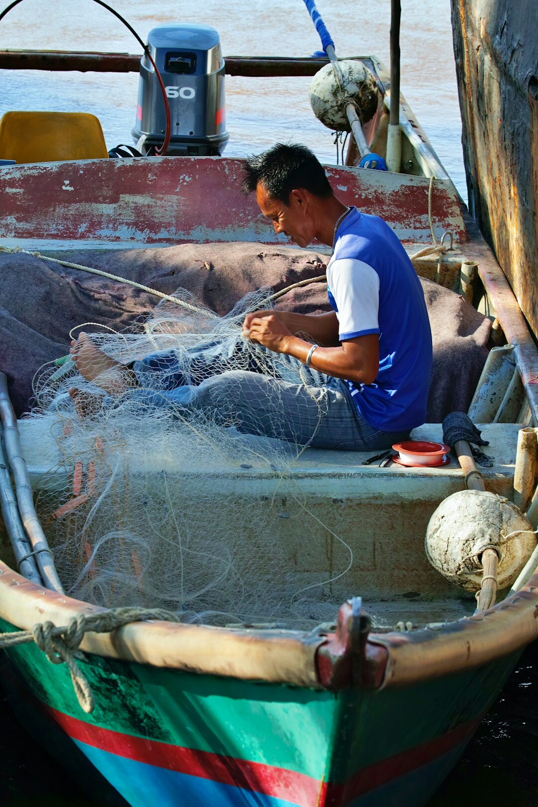 fishermen repairing nets