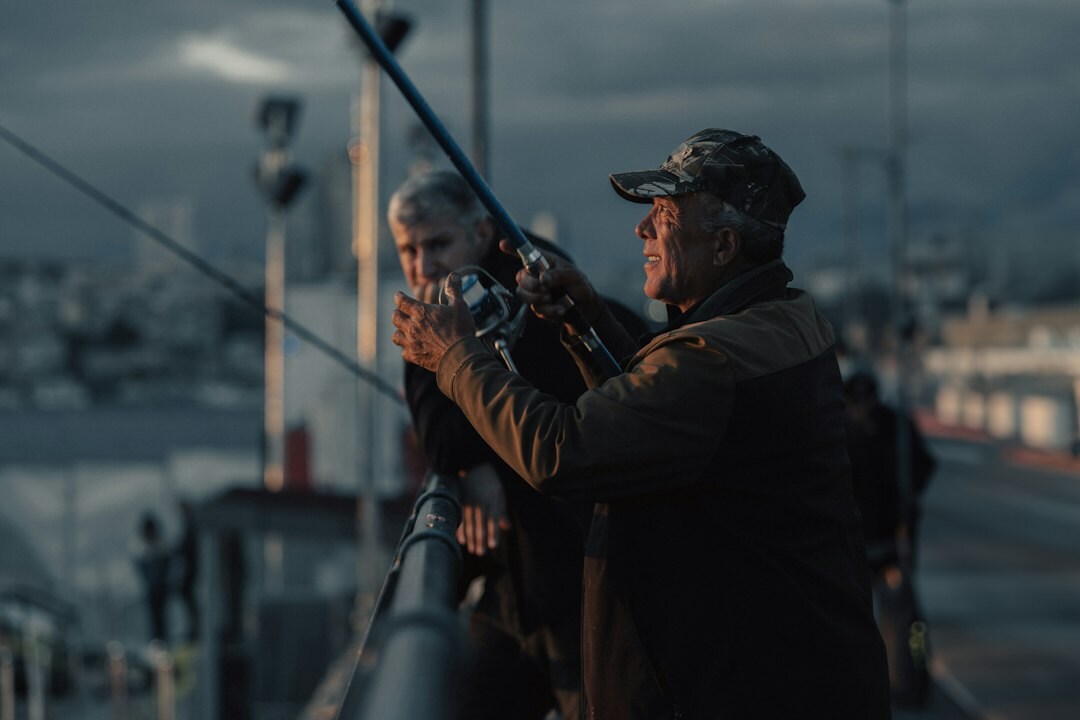 Photographer interviewing an elderly fisherman in a Danish coastal village